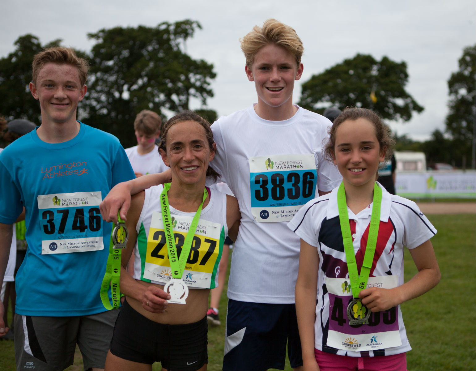 New Forest Marathon Races 2026 — family posing with finisher medals after three different race distances